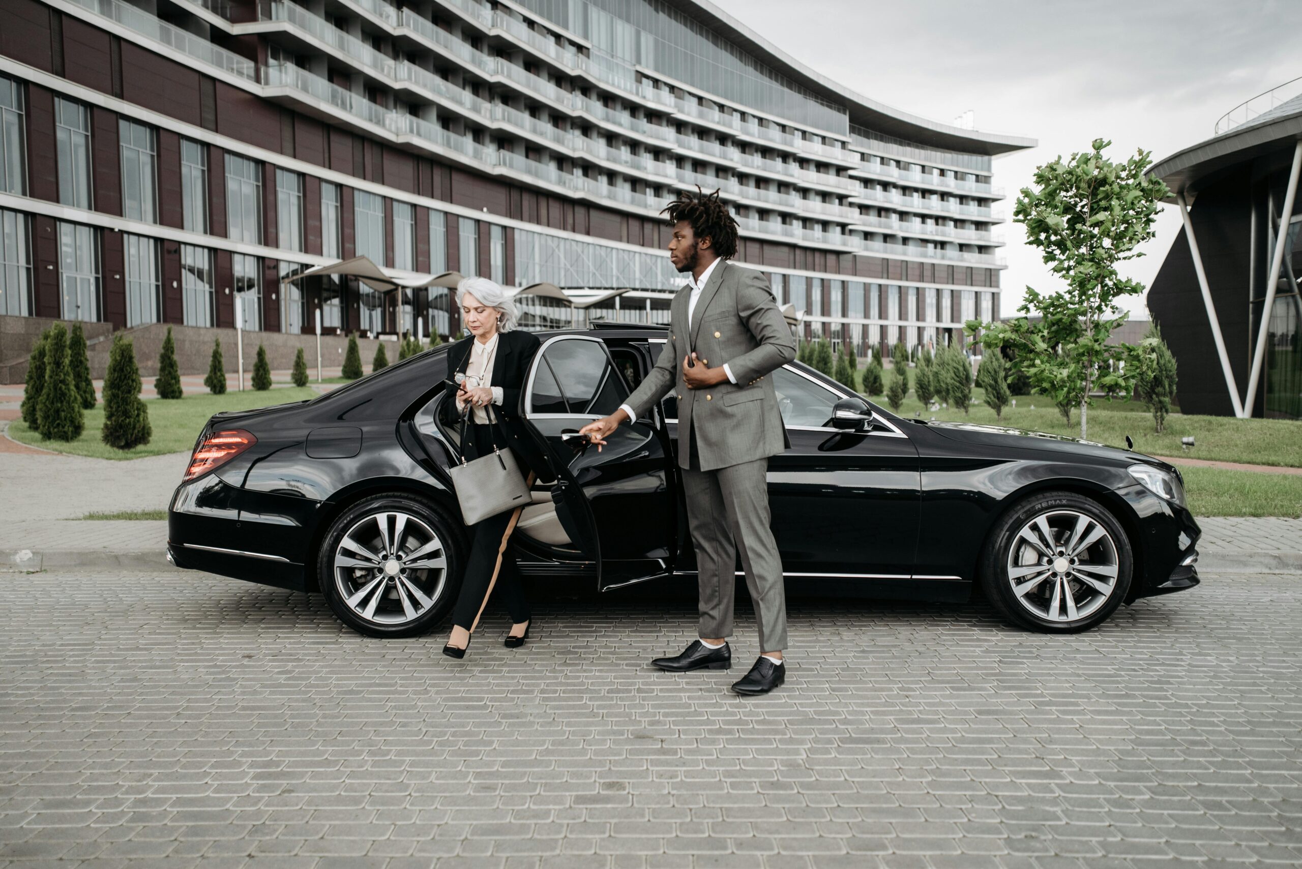 mercedes-opening-car image of a chauffeur opening the door to a woman